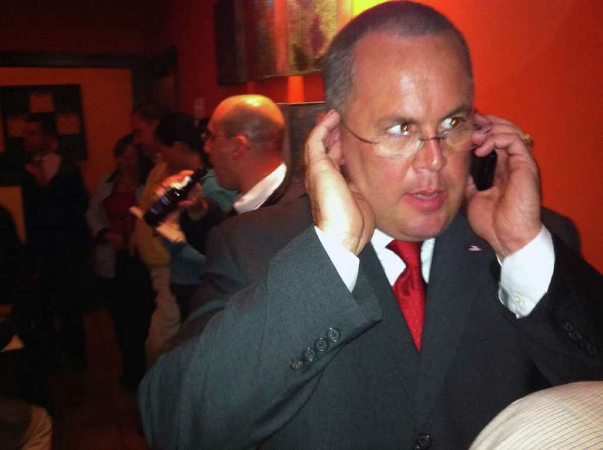 GOP first selectman candidate Kurt Miller talks to a supporter on his cell phone after his 1,846 to 1,496 victory in Seymour on Tuesday Nov. 8, 2011.