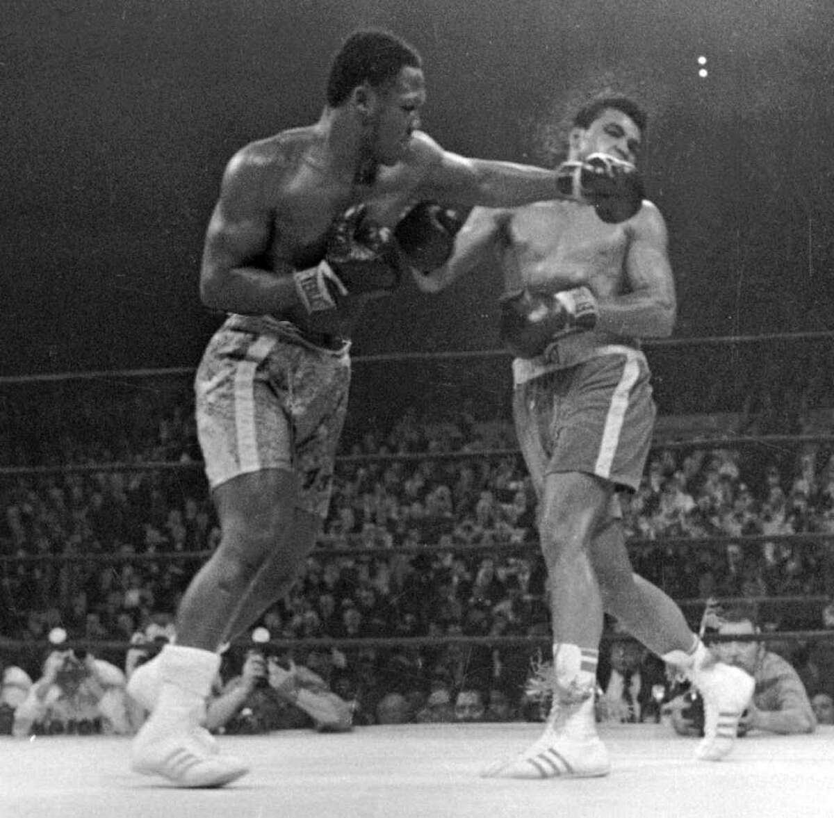 FILE - In this March 8, 1971, file photo, Muhammad Ali. right, takes a left from Joe Frazier during the 15th round of their heavyweight title boxing bout in New York. Frazier won a unanimous decision. Frazier, the former heavyweight champion who handed Ali his first defeat yet had to live forever in his shadow, died Monday Nov. 7, 2011 after a brief fight with liver cancer. He was 67. (AP Photo/File)