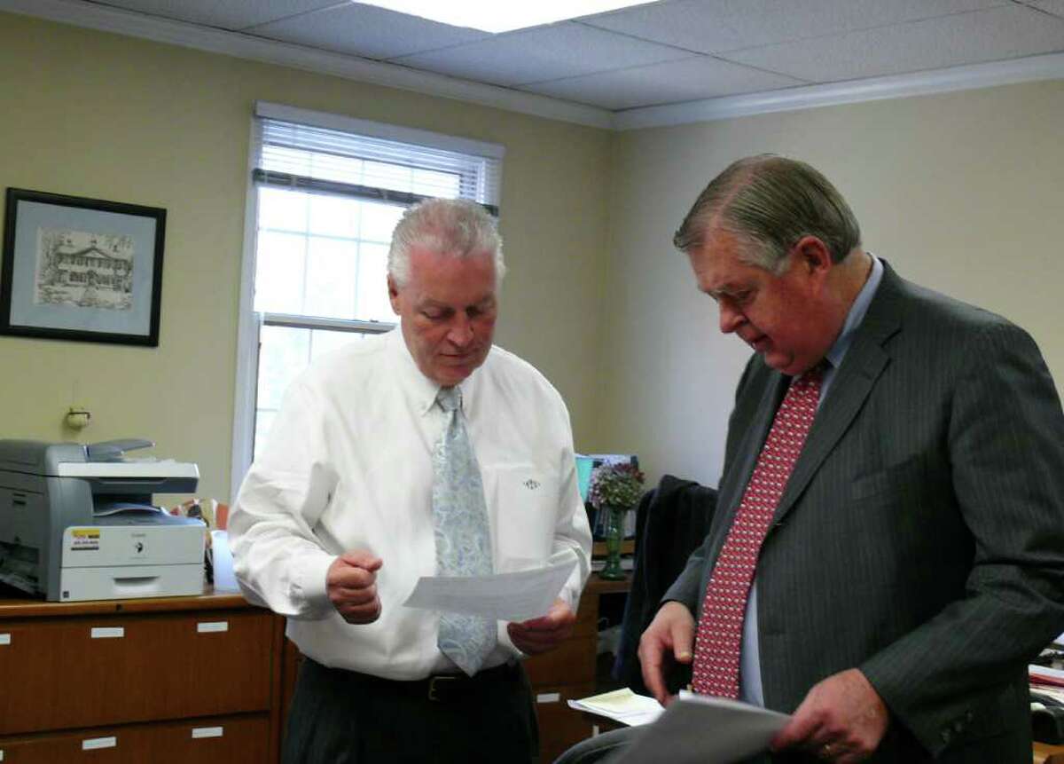 First Selectman Mike Tetreau, left, goes over some files with Fiscal Officer Paul Hiller Wednesday morning.