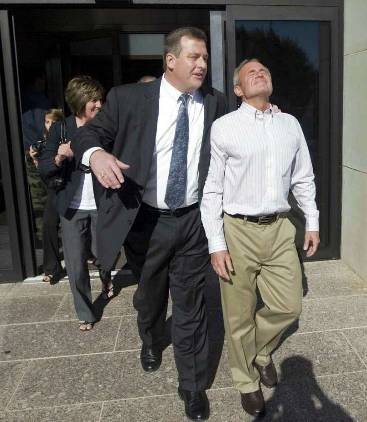 File - In this Oct. 4, 2011 file photo Michael Morton, right, leaves the Williamson County Justice Center in Georgetown, Texas, with lawyer John W. Raley, Jr. after a judge freed him. Morton, who spent nearly 25 years in prison in his wife's beating death, walked free Tuesday after DNA tests showed another man was responsible. The Innocence Project has accused the case’s original prosecutors of deliberately concealing evidence that likely would have helped Morton avoid being convicted in the first place. The district attorney who tried the original case, Ken Anderson, is now a district judge in Williamson County. (AP Photo/Austin American-Statesman, Ricardo B. Brazziell, File) MAGS OUT; NO SALES; TV OUT; INTERNET OUT; AP MEMBERS ONLY