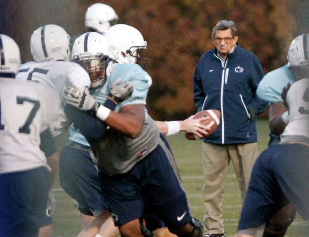 Penn State coach Joe Paterno watches his football team practice Wednesday. Not long after practice started, he was told by university officials that he had been fired by the board of trustees.