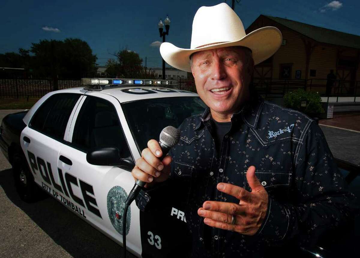 Tomball Police Chief Robert Hauck poses for a portrait while singing country music in front of a police cruiser on Wednesday, August 3, 2011 in Tomball. Hauck moved to Tomball from Los Angeles in June 2008, "I fell in love with this place," said Hauck, who sings country and gospel music at church and in the community. He won Tomball's American Country Idol contest. ( Patrick T. Fallon / Houston Chronicle )