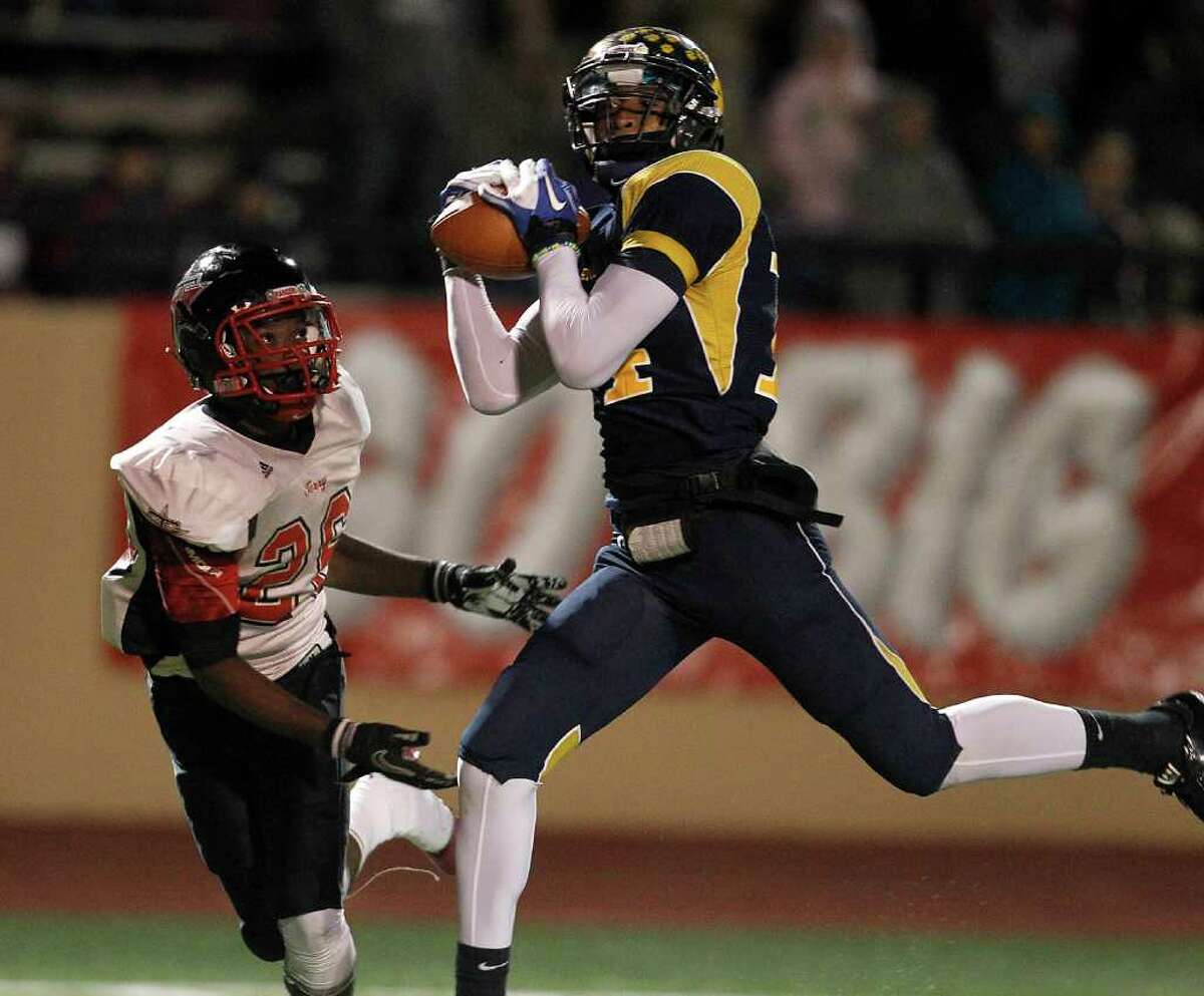 LaMarque's Brian Allen (14) makes a 44-yard touchdown catch against Terry's Victor Davis (26) during the fourth quarter of the high school football game at the Alvin Memorial Stadium, Nov. 10, 2011. LaMarque won the game against Terry High School 31-25. ( Karen Warren / Houston Chronicle )