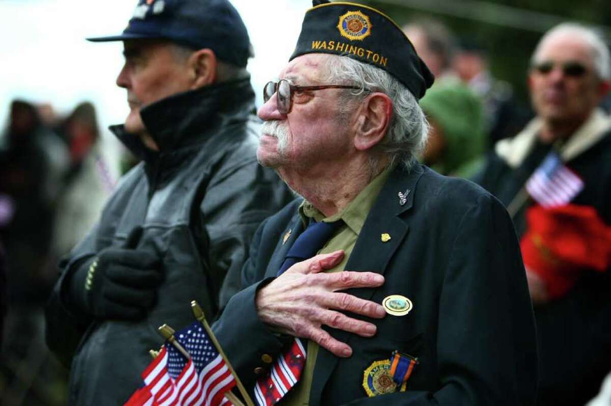 U.S. Navy veteran and American Legion member Walt Gallagher, 88, stands at attention as the Stars and Stripes is presented during the 62nd Annual Veterans Day Memorial Celebration at Evergreen-Washelli Cemetery on Friday, November 11, 2011.