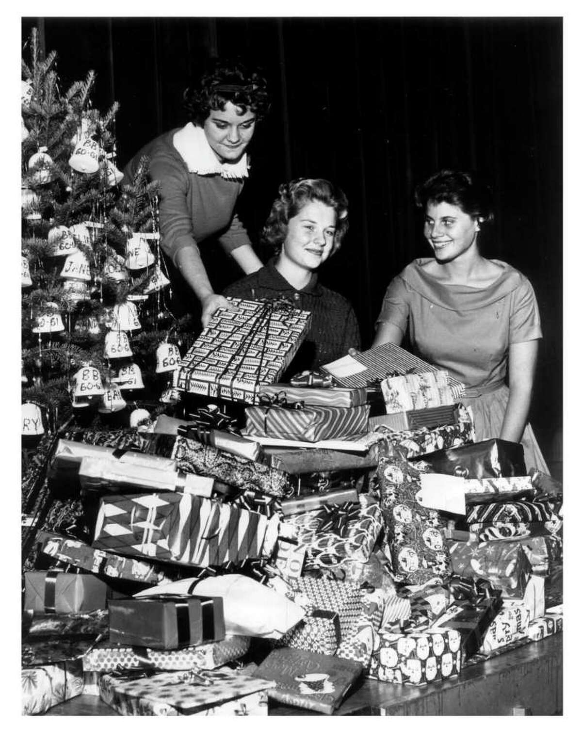Bellaire HS drill team members help collect gifts for Goodfellows program. L-R: Martha Reitz, 17; Vicki Hoffman, 16; Irene Kaye, 16