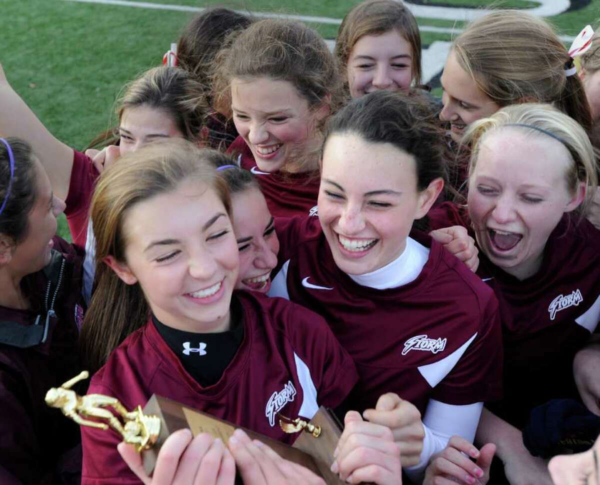 Hannah Butman, lower left, of St. Luke's School, clutches the championship trophy surrounded by teammates after defeating Greenwich Academy in the FAA girls soccer championship between St. Luke's School and Greenwich Academy at St. Luke's, New Canaan, Nov.11, 2011.