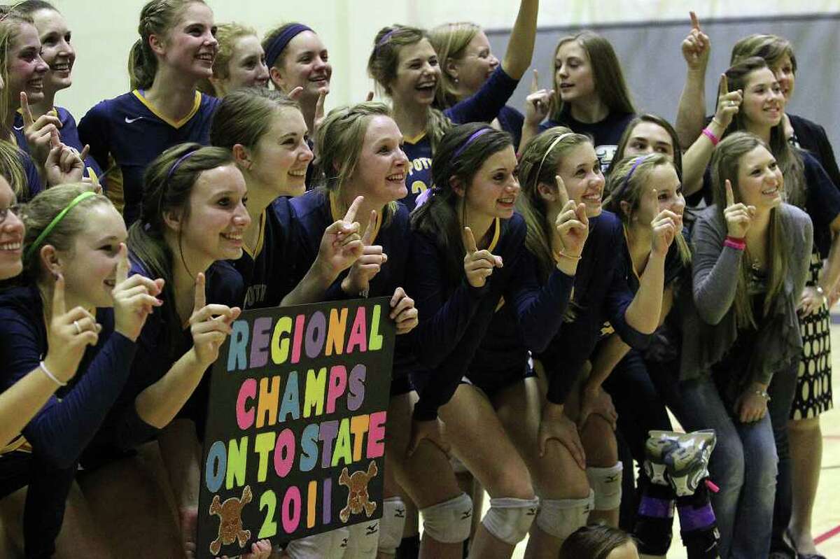 Members of the Poth volleyball team pose for pictures from family members and fans after they defeated Marion in the Region IV-2A volleyball championship game at Littleton Gym on Saturday, Nov. 12, 2011. Poth defeated Marion in three straight games to move onto the state tournament.