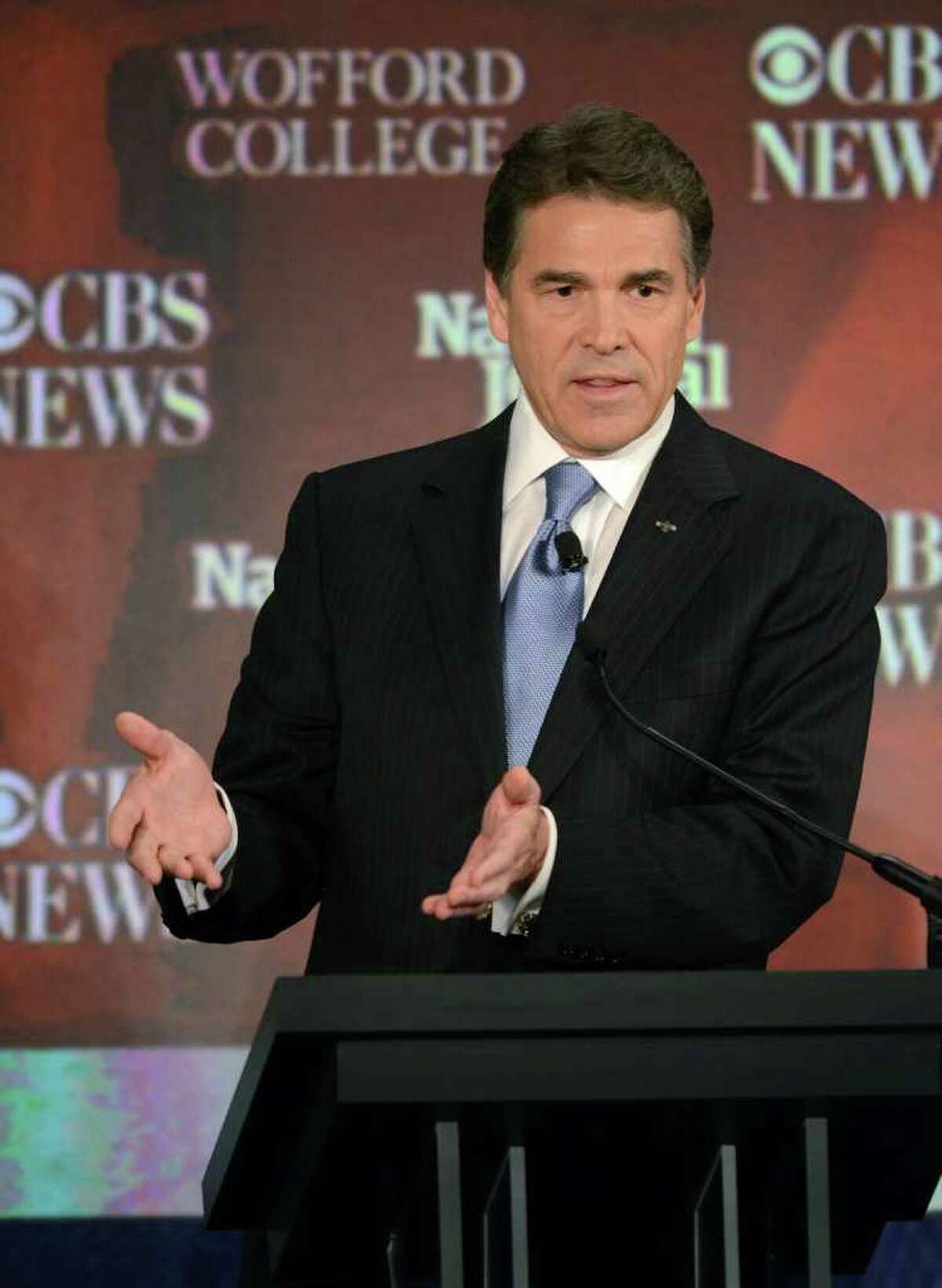 Republican presidential candidate Rick Perry, Texas Governor, speaks at the CBS News/National Journal foreign policy debate at the Benjamin Johnson Arena, Saturday, Nov. 12, 2011 in Spartanburg, S.C. The debate covered foreign policy, which has gotten little attention from the GOP candidates in recent weeks. During the debate Perry joked about his gaffe from a debate four days ago, when he forgot the third Cabinet department he would eliminate if elected president.