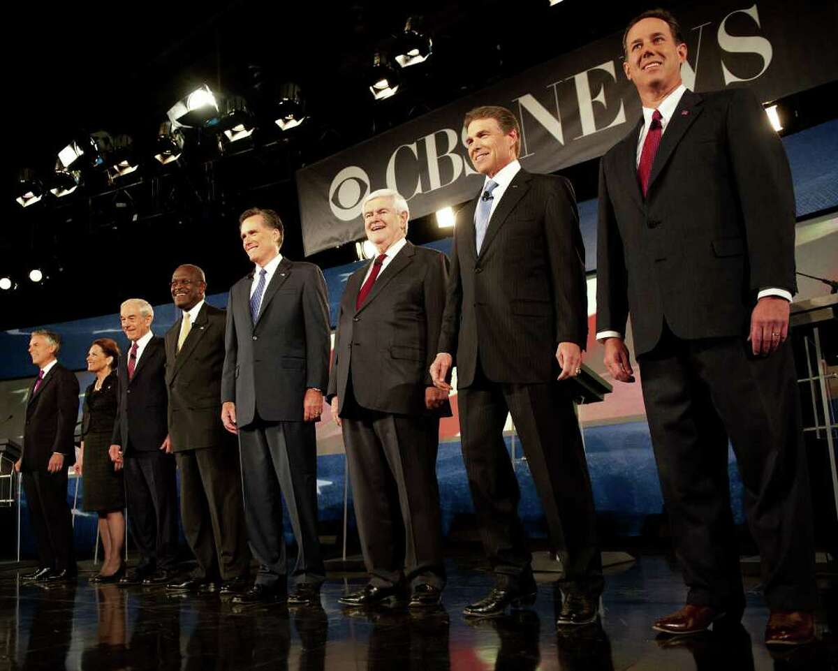 PAUL J. RICHARDS : AFP/GETTY IMAGES LINED UP : Republician Presidential hopefuls, from left, Jon Huntsman, Michele Bachmann, Ron Paul, Herman Cain, Mitt Romney, Newt Gingrich, Rick Perry and Rick Santorum participate in the South Carolina Presidential Debate.