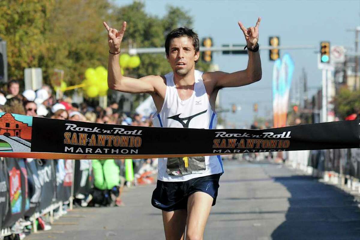 David Fuentes, a former standout in cross country at Boerne High School, crosses the finish line in first place during the 2011 San Antonio Rock 'n' Roll Marathon in San Antonio, Texas on November 13, 2011. John Albright / Special to the Express-News.