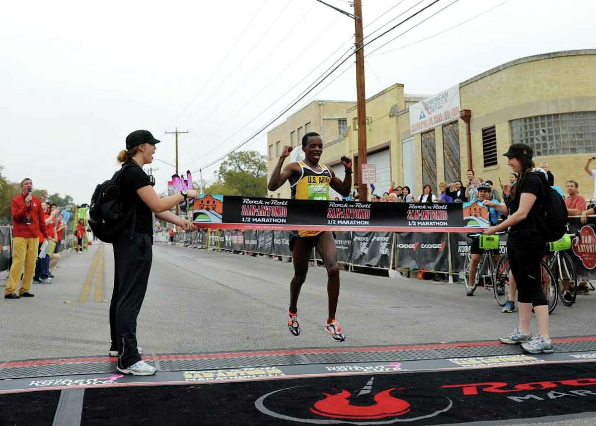 Augustus Mayo crosses the finish line of the half marathon in first place during the 2011 San Antonio Rock 'n' Roll Marathon and Half Marathon in San Antonio, Texas on November 13, 2011. John Albright / Special to the Express-News.