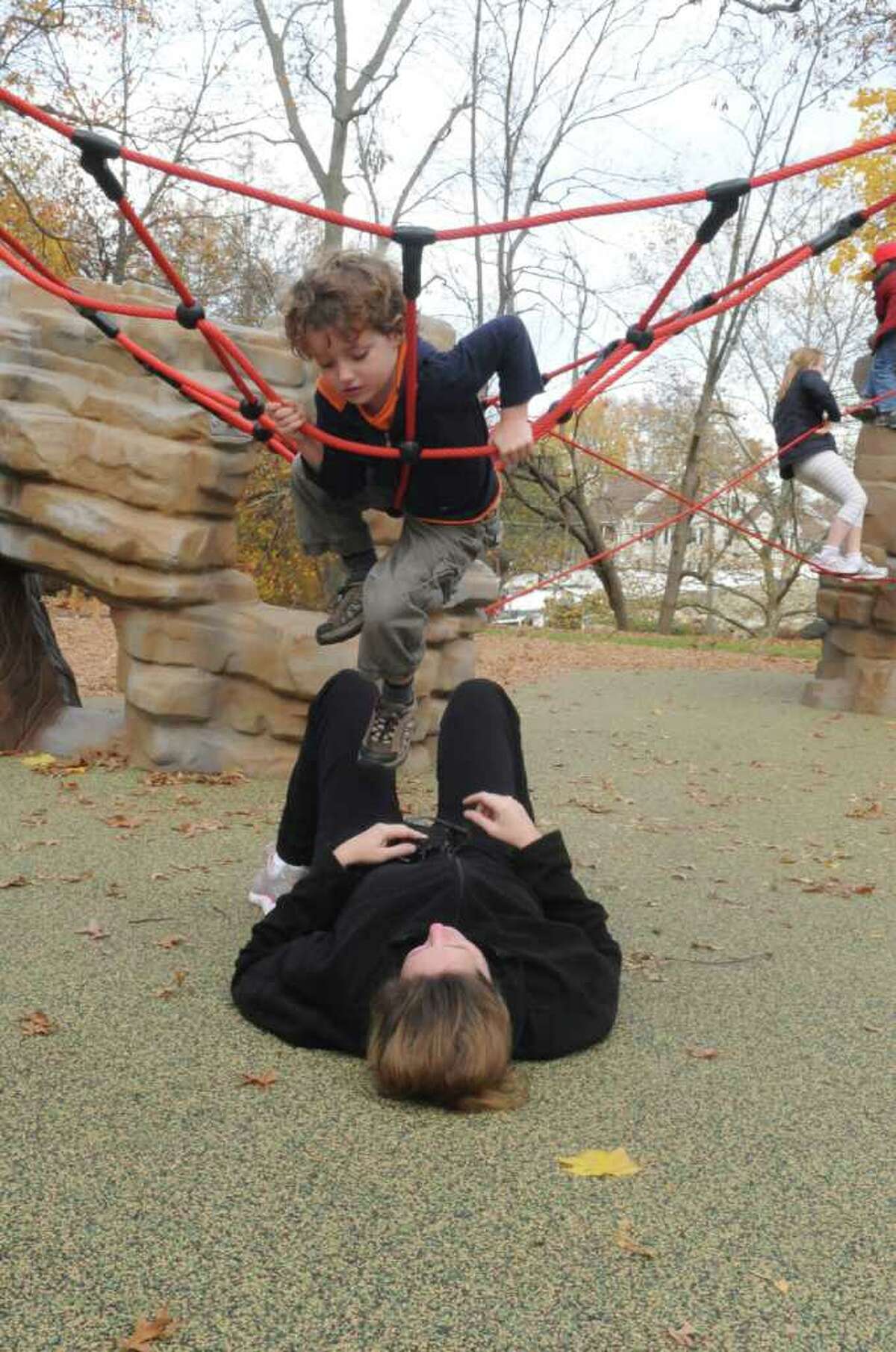 Katie Bistrian, of Greenwich, watches her son Bass, 4, play at the "Rocks and Ropes" playground. The Junior League of Greenwich hosted a ribbon-cutting ceremony for the Bruce Park Boundless playground's "Rocks and Ropes" Sunday, Nov. 13, 2011.