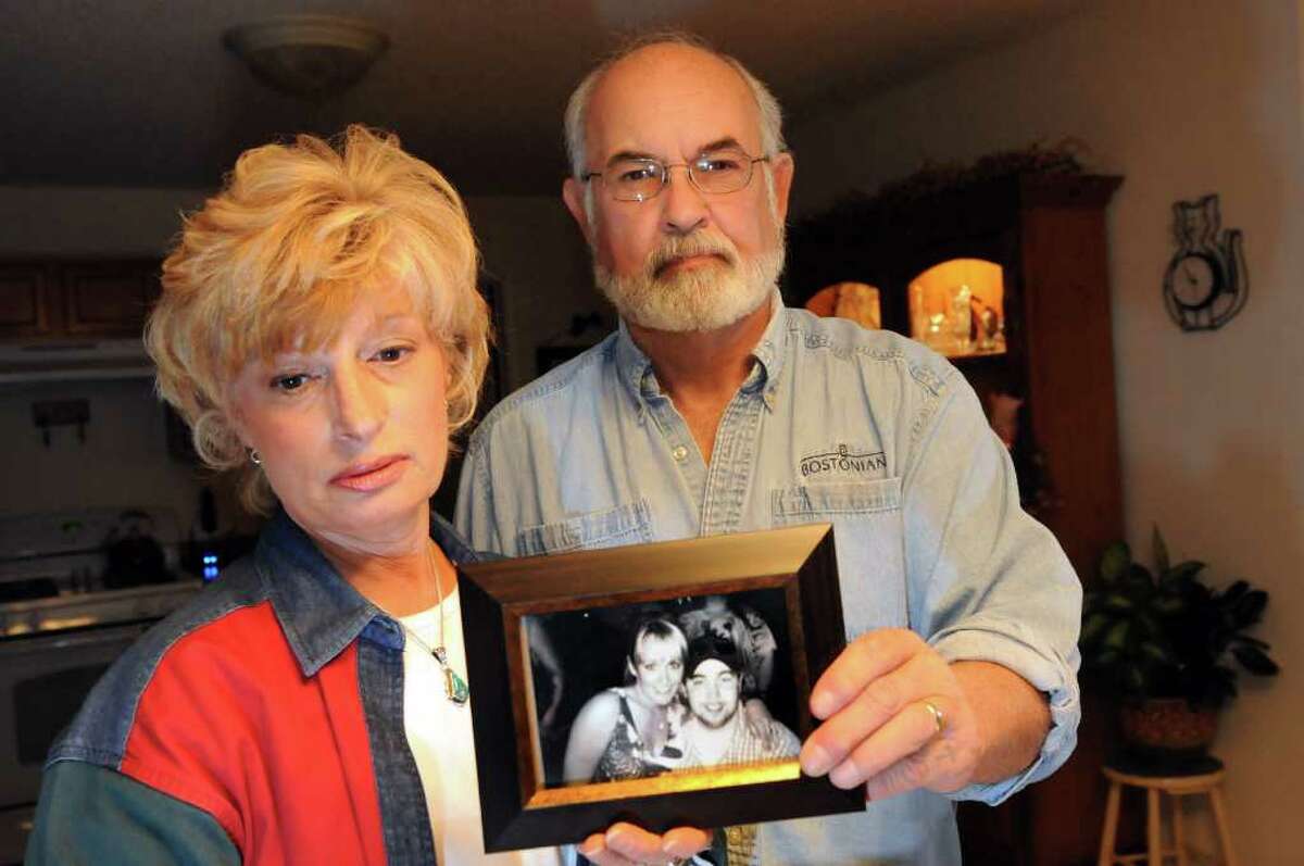 Sheila and Keith Simpson hold a photograph of Jennifer and her brother Jeremy on Friday, Nov. 11, 2011, at their home in Halfmoon, N.Y. Jennifer was found dead in Florida this spring, and her father and step mother are still trying to find answers. (Cindy Schultz / Times Union)