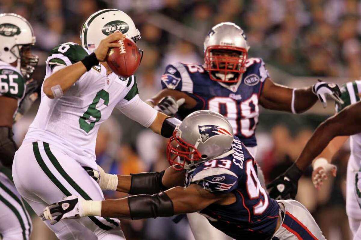 EAST RUTHERFORD, NJ - NOVEMBER 13: Mark Sanchez #6 of the New York Jets gets sacked by Andre Carter #93 of the New England Patriots at MetLife Stadium on November 13, 2011 in East Rutherford, New Jersey. (Photo by Nick Laham/Getty Images)