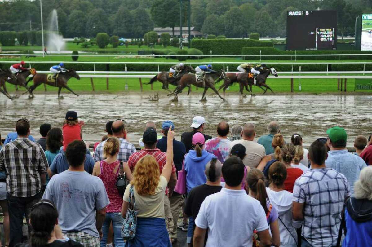 Race fans cheer on horses as they head to the finish line of the 5th race on the last day of racing for the year at Saratoga Race Course on Monday Sept. 5, 2011 in Saratoga Springs, NY. (Philip Kamrass / Times Union)
