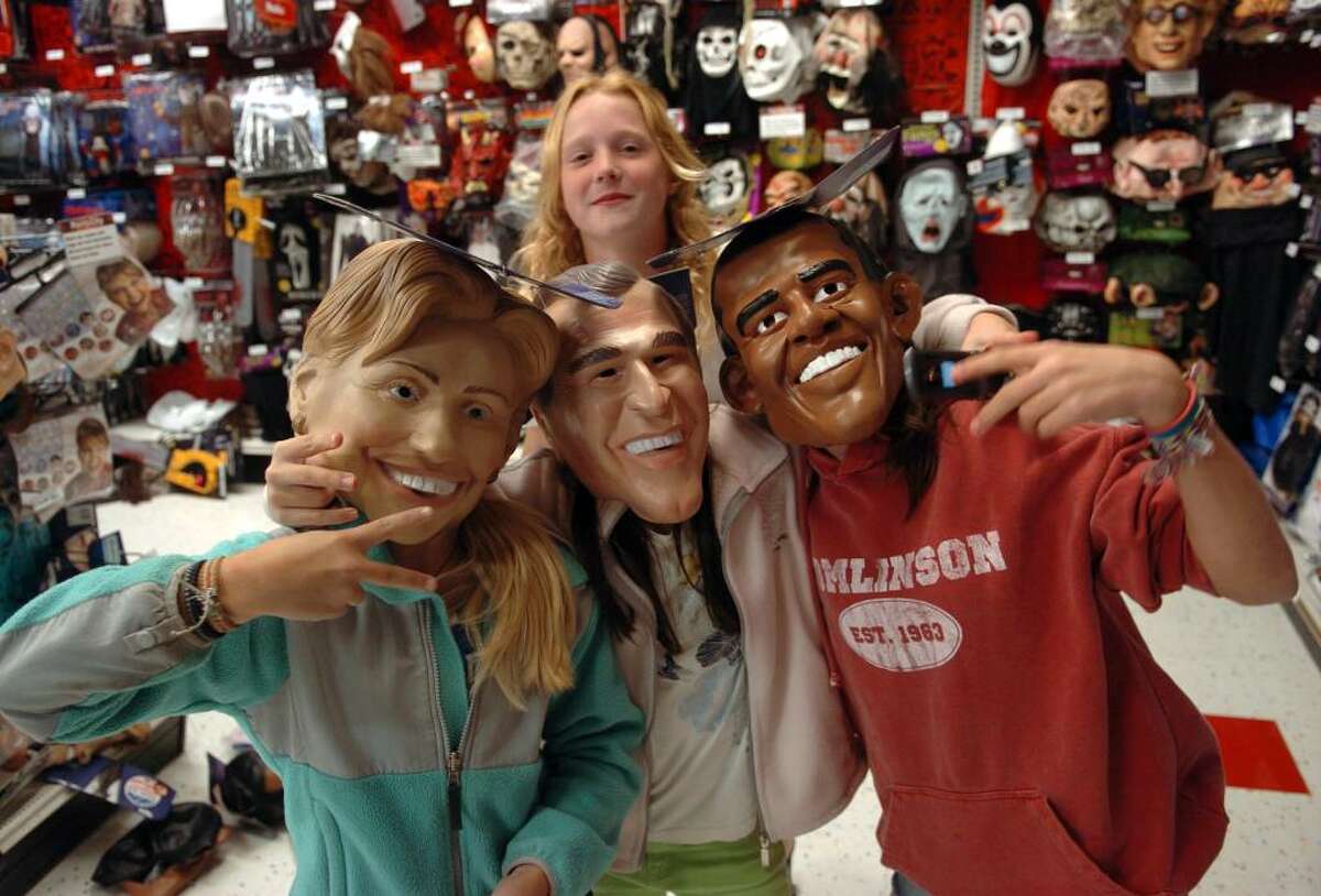 Kids and parents spend time finding the perfect Halloween costume at Party City in Fairfield, Conn. on Wednesday night Oct. 14, '09. Here whiel shopping for costumes, Ellie Kreitler, 11, left, wears a Hillary Clinton Mask, Nicki Cronan, 11, has on a President George W. Bush Mask, and Maddy Low, also 11, has on a President Obama mask. In back is friend Laura McDonald.