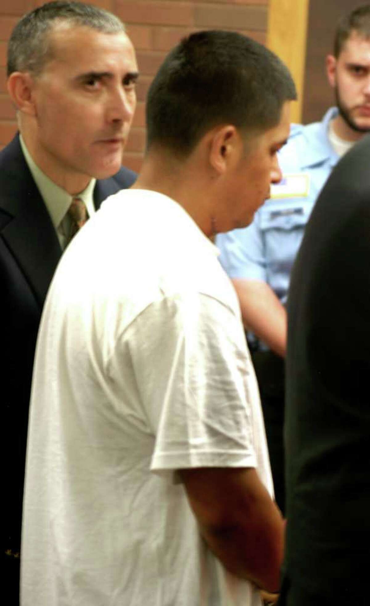 Interpreter Javier Lillo, left, looks on as Arturo Dota, the Danbury man accused of killing Natalie Ramirez in their Duck Street apartment Monday night, pleads not guilty to murder during an appearance in state Superior Court in Danbury on Thursday, Aug. 25, 2011.
