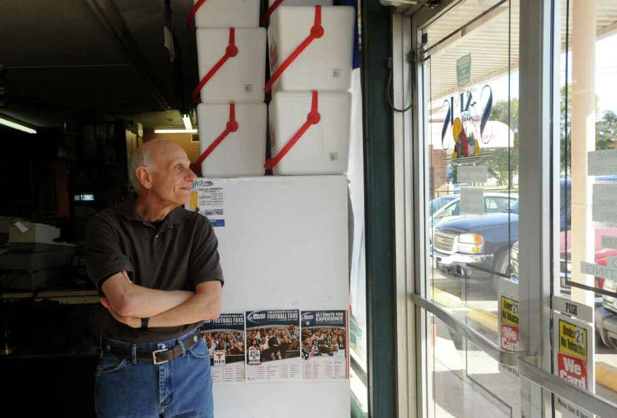 Joe Parigi, who runs 8 miles a day, likes to meet the delivery trucks before the store opens, is in the store 12 hours a day, six days a week, is unsure what he will be doing in retirement but knows spending more time with his five grandchildren will be a priority. Skylar Thompson, of Market Basket, is the new owner of Sam's Package Store, at 4350 E. Lucas Drive. Parigi, who has owned the store for 31 years, is retiring and selling the store so he and his wife, Peggy, can do other things. Dave Ryan/The Enterprise