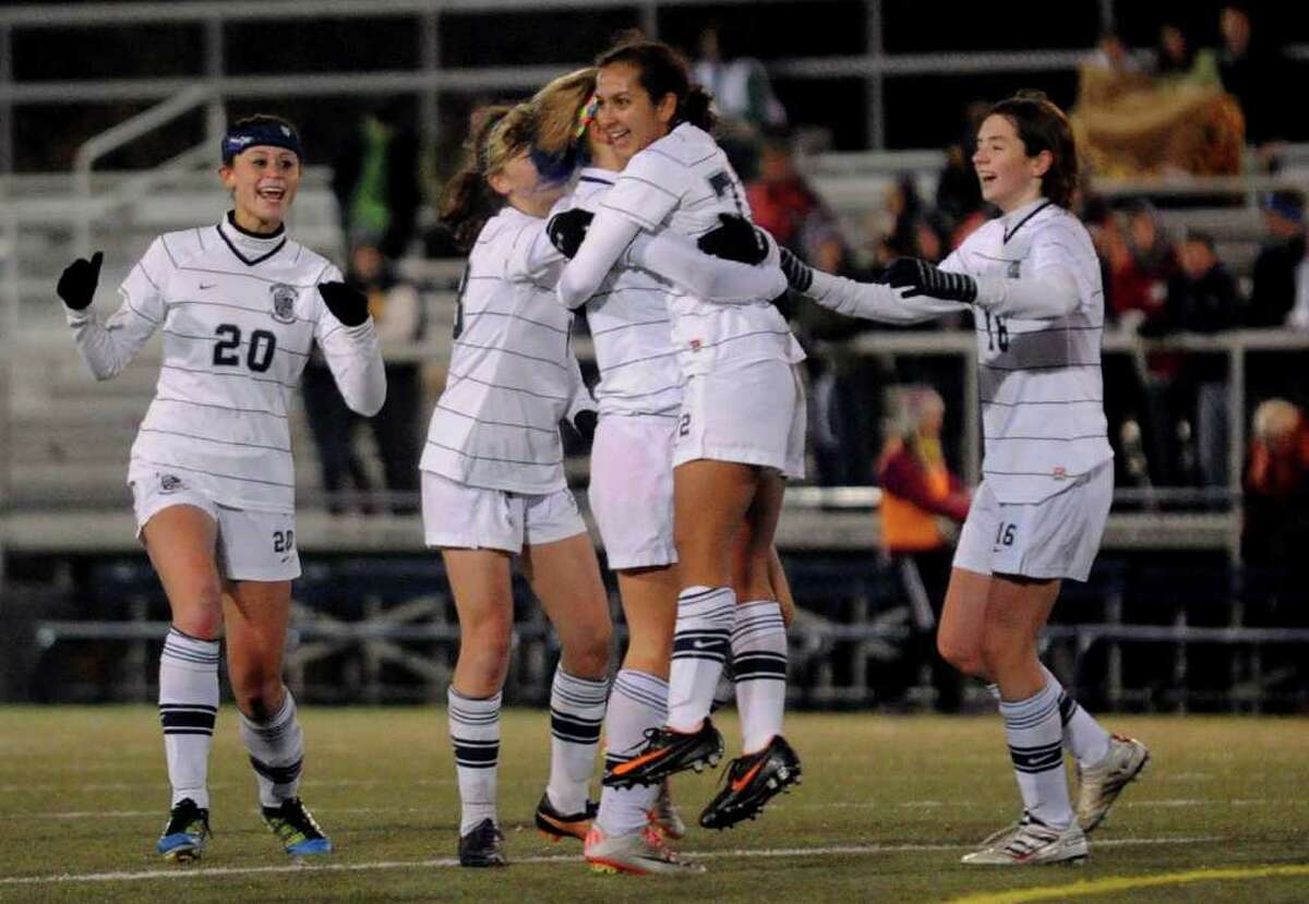 Immaculate teammates hug and surround #72 Natalia Diaz after she scored a goal against Bolton, during CIAC Girls Soccer State Tournament Class S Semifinal action in Waterbury, Conn. on Friday November 18, 2011.
