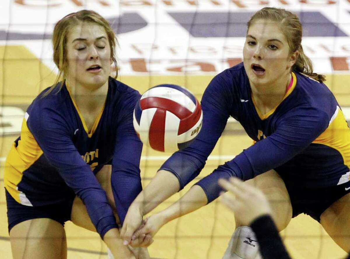 Poth's Corin Nelson, left, and Jordan Kotara work for a dig during game action of the class 2A state volleyball final against Nocona at Strahan Coliseum at Texas State University on Saturday, Nov. 19, 2011. MICHAEL MILLER / mmiller@express-news.net