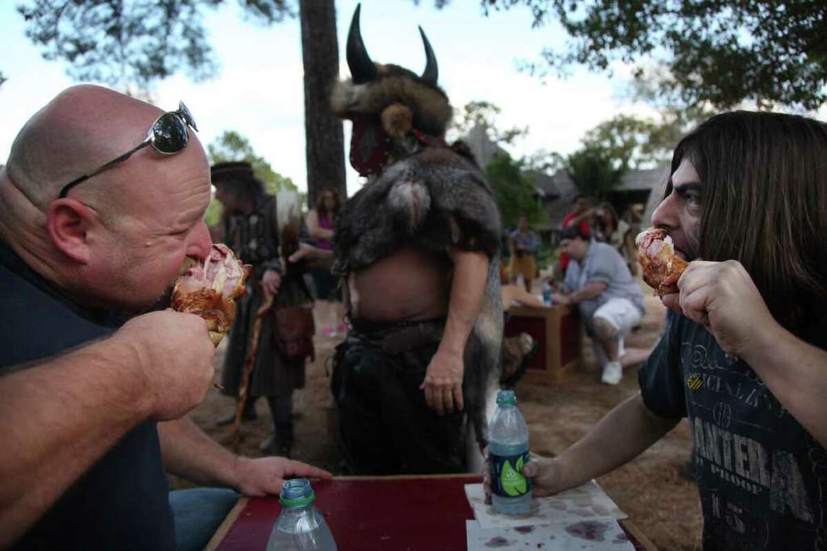 (Left to right) Mike Williamson, of Magnolia, and Logan Dergan, of Spring, quickly eat a turkey leg during the "Turkey Leg Eating Contest" at the Renaissance Festival on Sunday, Nov. 20, 2011, in Plantersville. Dergan won the competition.