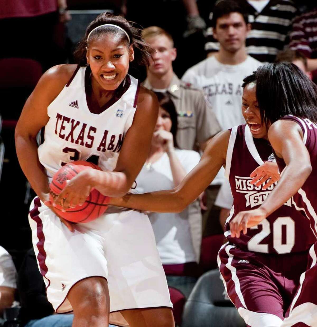 Texas A&M's Karla Gilbert grabs a rebound from Mississippi State's Shamia Robinson.