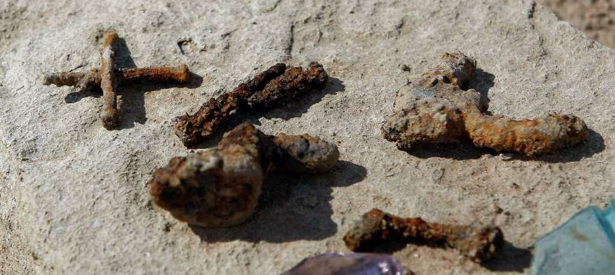 In this Oct. 5, 2011 photo, rusty nails and other artifacts, normally at least 20 to 30 feet underwater, have joined other remnants of old Bluffton, Texas, resurfacing on the now dry, sandy lake, near Bluffton, as the Texas drought shrinks the state's largest inland lake. (AP Photo/Eric Gay)