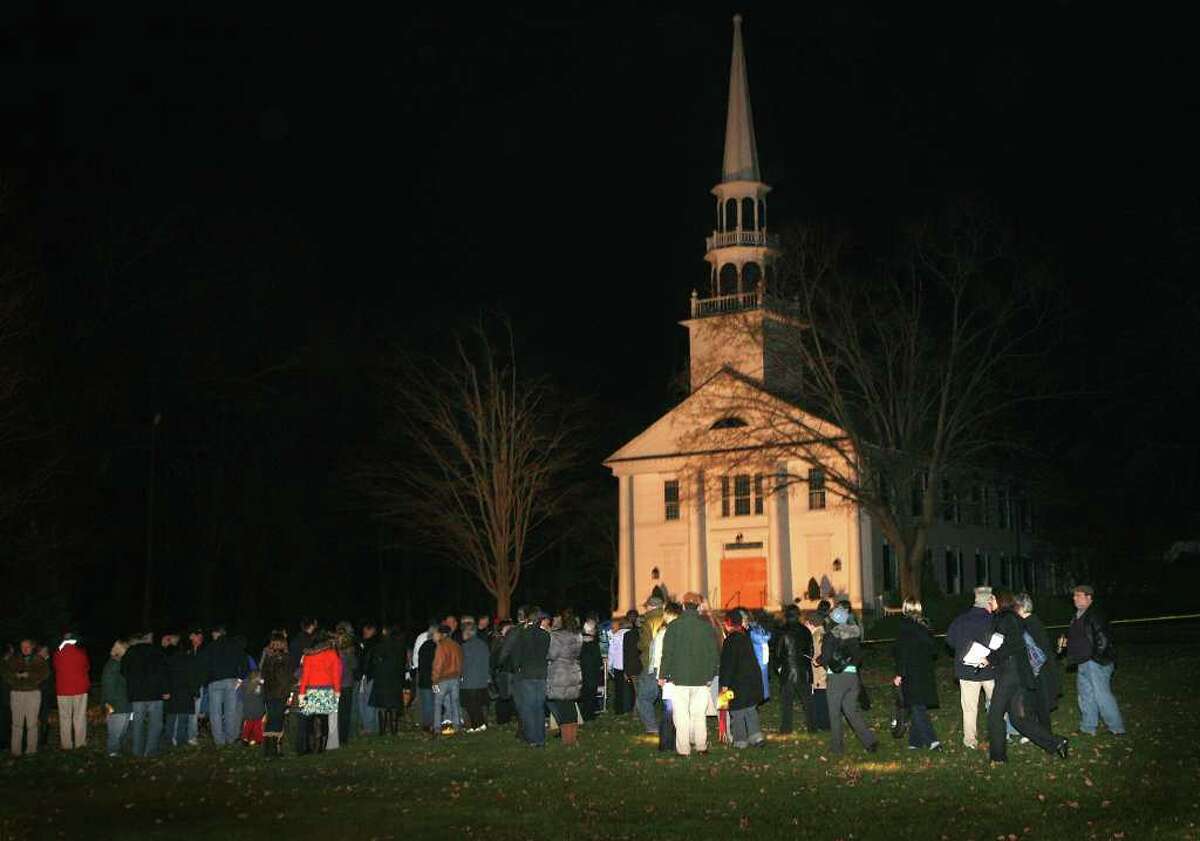 Congregants gather for a prayer service on the lawn in front of the Saugatuck Congregational Church at 245 Post Road East in Westport on Monday evening, November 21, 2011. The church was severely damaged by a fire on Sunday night.