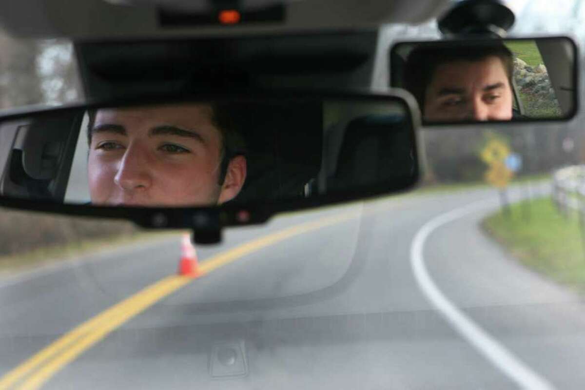 Weston HIgh School student Max Catucci, 16, left, takes a driving lesson with Matt Debernardis, of All-Star Driver, on Monday, November 21, 2011.