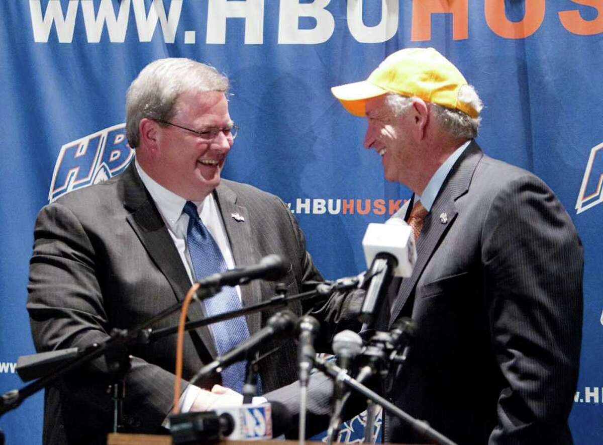 BOB LEVEY: FOR THE CHRONICLE SEALING THE DEAL: HBU president Robert B. Sloan Jr., right, shakes hands with Southland Conference commissioner Tom Burnett after accepting an invitation to join the league.