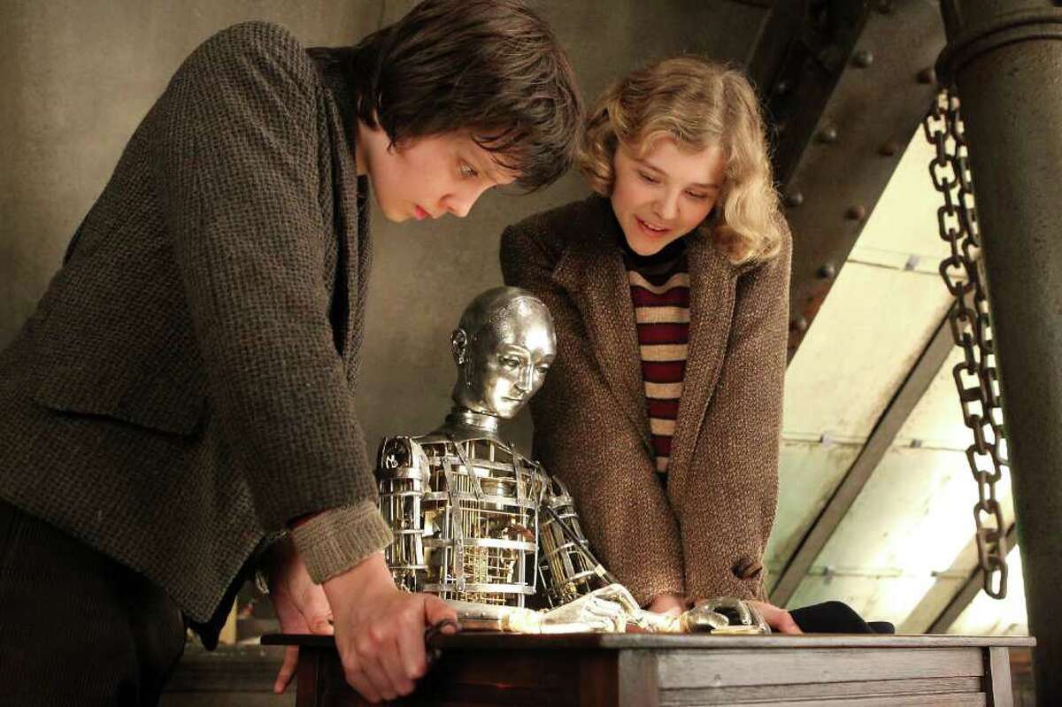 JAAP BUITENDIJK PALS: Hugo (Asa Butterfield) and Isabelle (Chloë Grace Moretz) work with the automation Hugo's father created.