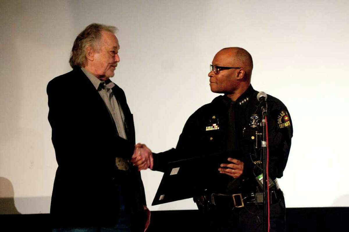 Dallas Police Chief David O. Brown, right, presents a Citizen's Certificate of Merit to Johnny Calvin Brewer, who led police to the arrest of President John F. Kennedy assassin Lee Harvey Oswald, at the Texas Theatre, Tuesday, Nov. 22, 2011, in Dallas. Kennedy was assassinated in Dallas on Nov. 22, 1963. (AP Photo/Jeffrey McWhorter)