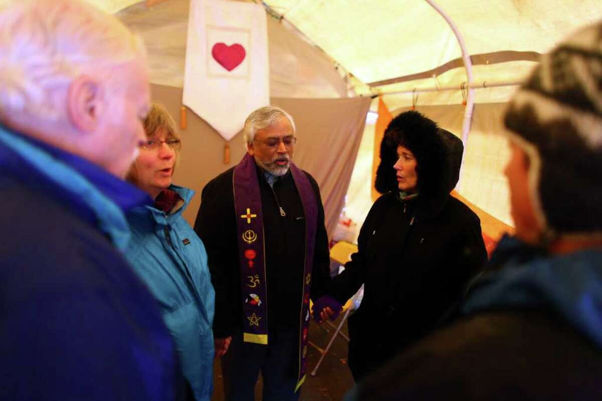 Muslim imam Jamal Rahman, center, leads a chant in the meditation tent at the Occupy Seattle encampment at Seattle Central Community College.