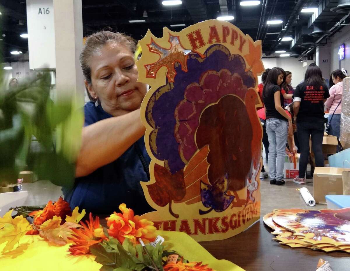 Jeannette Flores creates a table centerpiece for the annual Raul Jimenez Thanksgiving Dinner at the Convention Center, Nov. 23, 2011.
