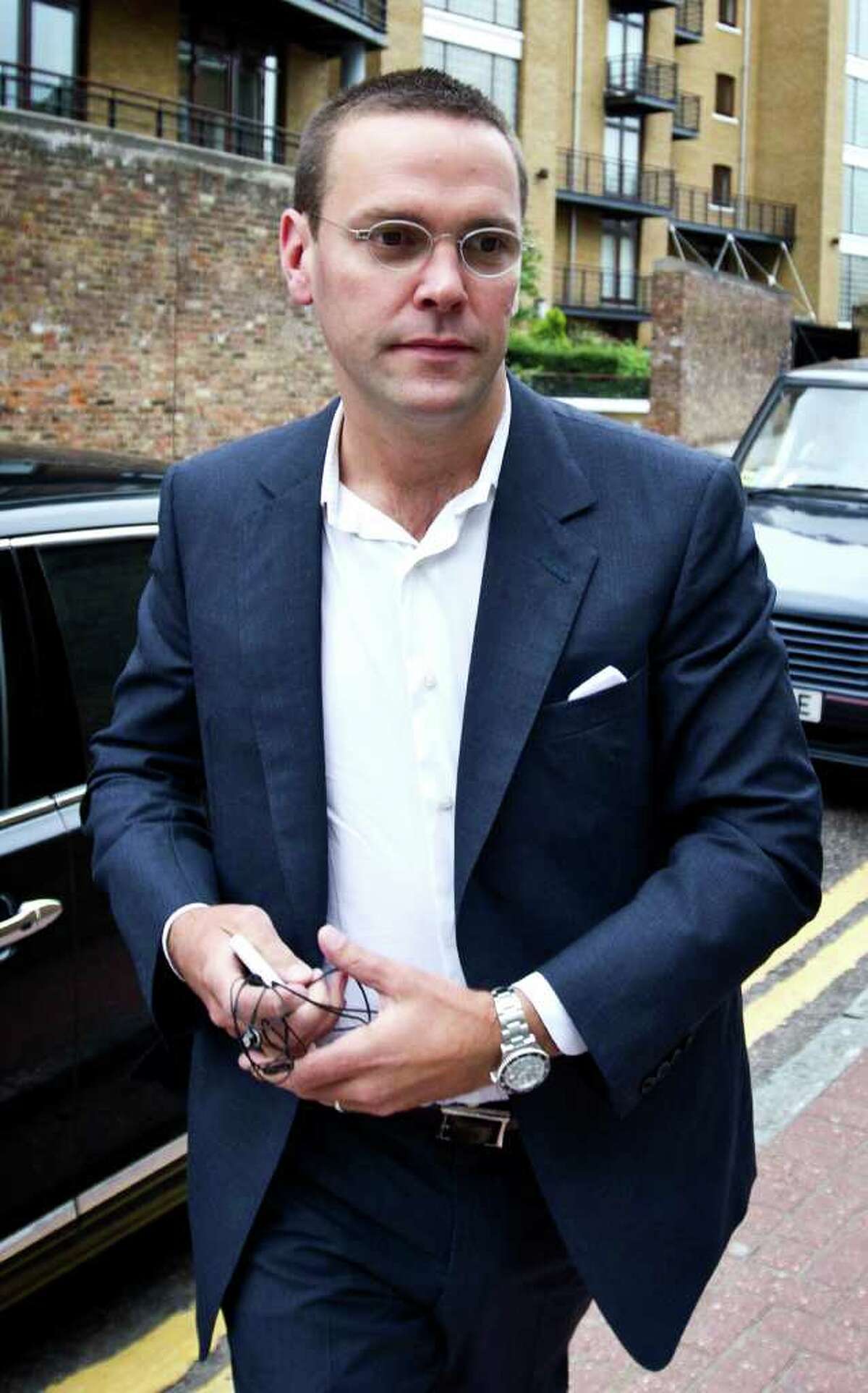 (FILES) A file picture taken on July 13, 2011, shows James Murdoch arriving for work in east London. James Murdoch has resigned as a director of several British newspapers including The Sun and The Times, documents and sources said Wednesday November 23, 2011, in the latest shake-up at his father Rupert's empire. AFP PHOTO / Warren Allott (Photo credit should read Warren Allott/AFP/Getty Images)