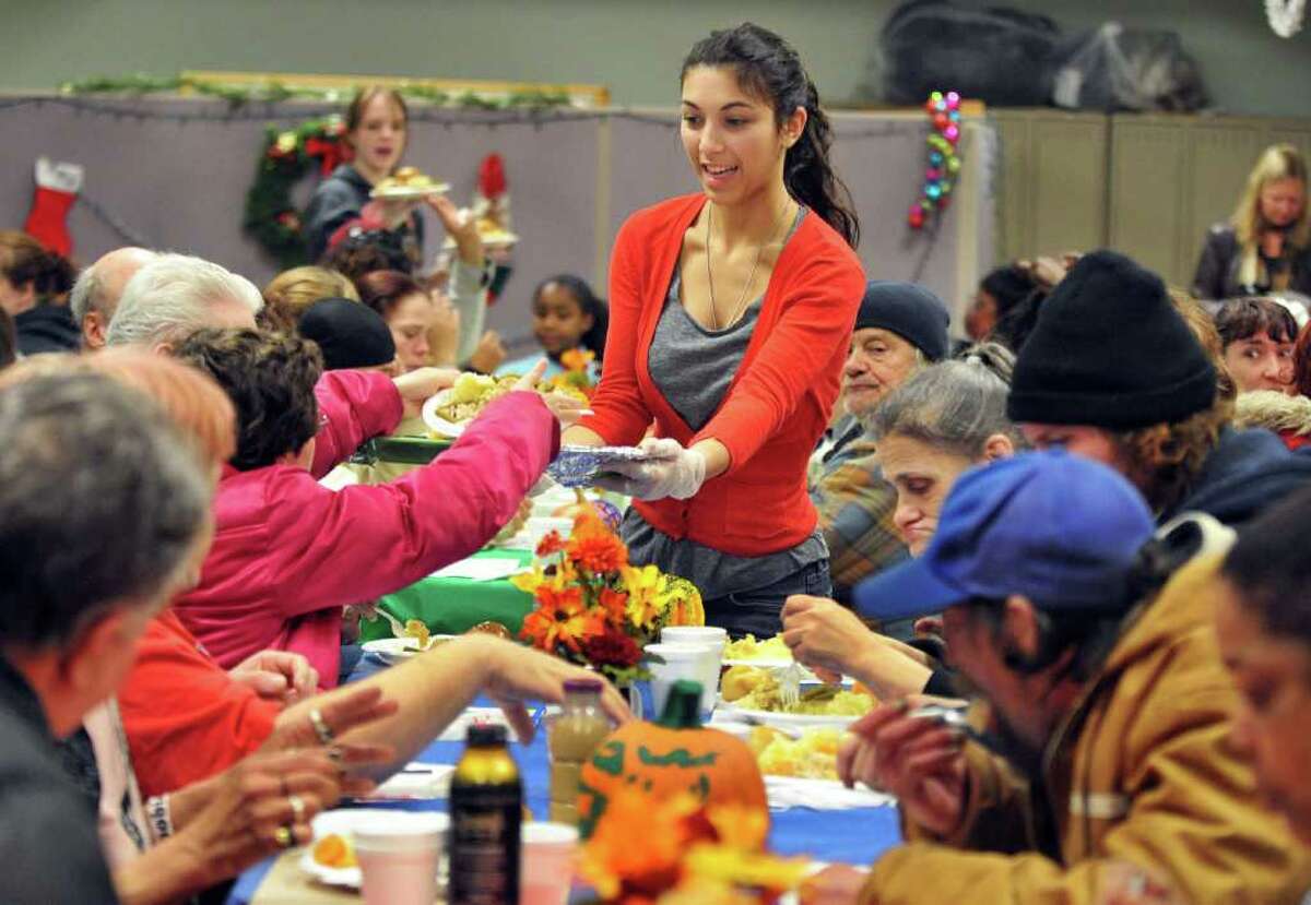 Niskayuna High senior Mia Gorla, top, serves meals at Bethesda House of Schenectady's early Thanksgiving Day meal Wednesday Nov. 23, 2011. Members of Niskayuna High's National Honor Society volunteered for the annual event. (John Carl D'Annibale / Times Union)