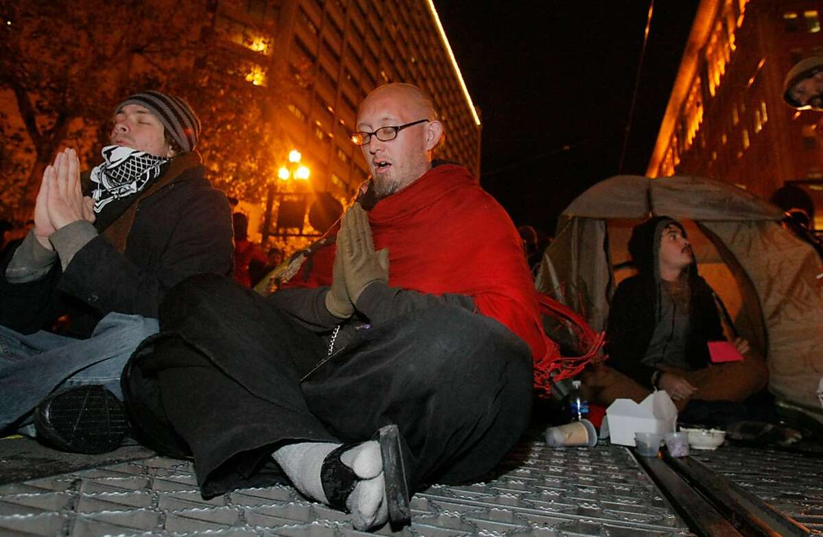 Occupy protesters blocked traffic on Market St. in front of the Federal Reserve Bank in San Francisco, Calif., on Sunday, Nov. 20, 2011. Police were on hand, but did not take any immediate action to remove the protesters.