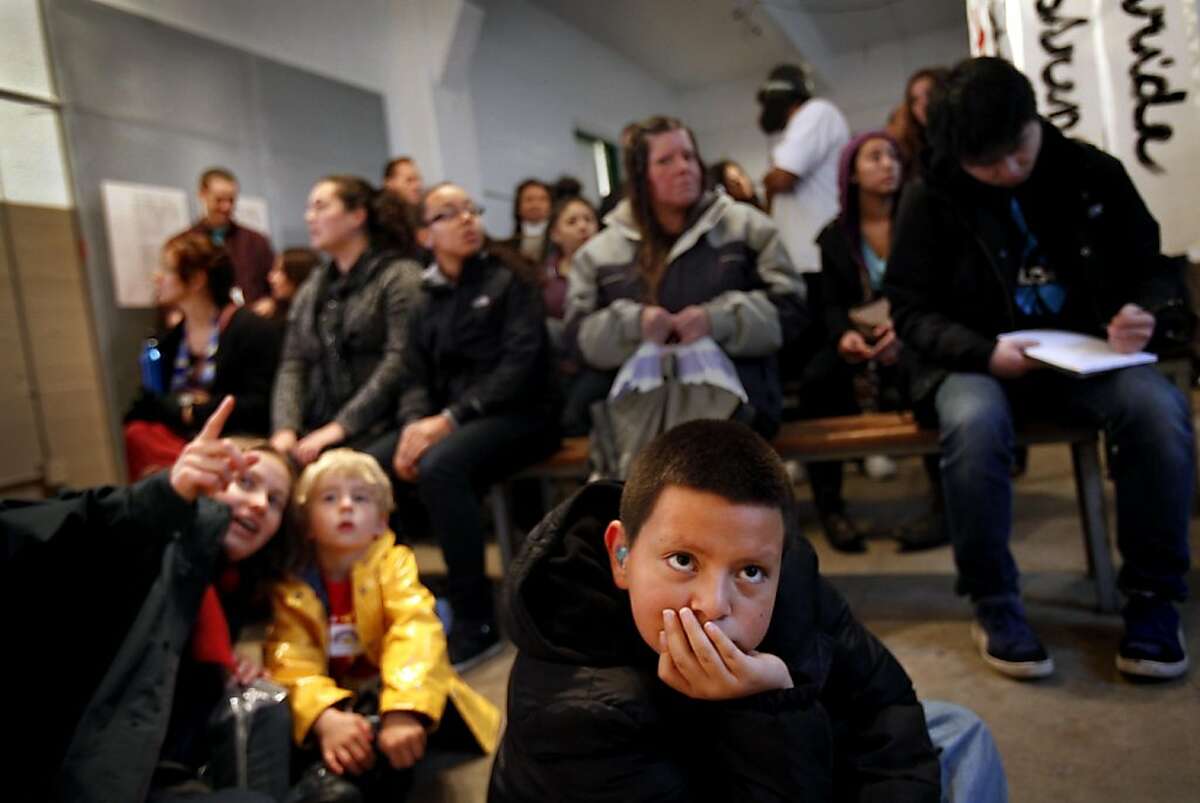 Taviano Sanchez, 10, of Union City, watches the movie at the grand opening of "We Are Still Here," a multi-media exhibit on the American Indian occupation of Alcatraz Island, on Alcatraz in San Francisco, Calif., Sunday, November 20, 2011. Sanchez came to the opening with his mother, who came to the occupation of Alcatraz with her mother when she was a child.