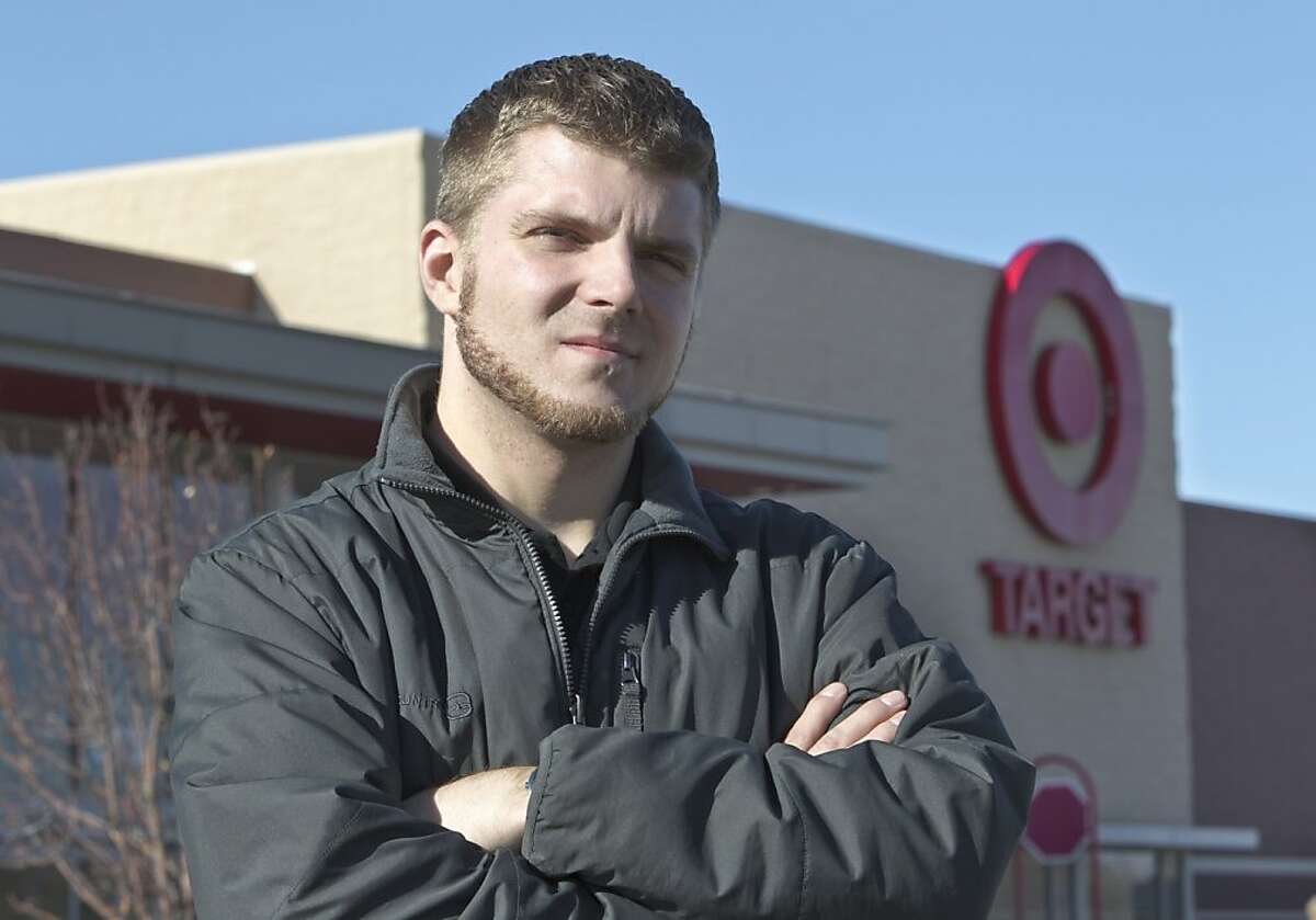 Anthony Hardwick, a part-time employee at a north Omaha Target store, poses for a photo in front of his place of employment, in Omaha, Neb., Tuesday, Nov. 15, 2011. Hardwick launched a petition asking Target department stores to drop plans to open at midnight on Thanksgiving Day , when he learned of the chain's plans to have employees report to work at 11 p.m. Thanksgiving Day to work 10-hour overnight shifts. Merchants are competing for shoppers on a weekend that can be critical for their annual sales and profits, and a growing number fear opening at 4 a.m. or 5 a.m., as they have in recent years, may be too late in this challenging economy(AP Photo/Nati Harnik) Ran on: 11-19-2011 Anthony Hardwick stands in front of the Omaha Target. He started a petition on Change.org protesting the plan to open at midnight on Thanksgiving. It went viral, drawing more than 180,000 signatures.