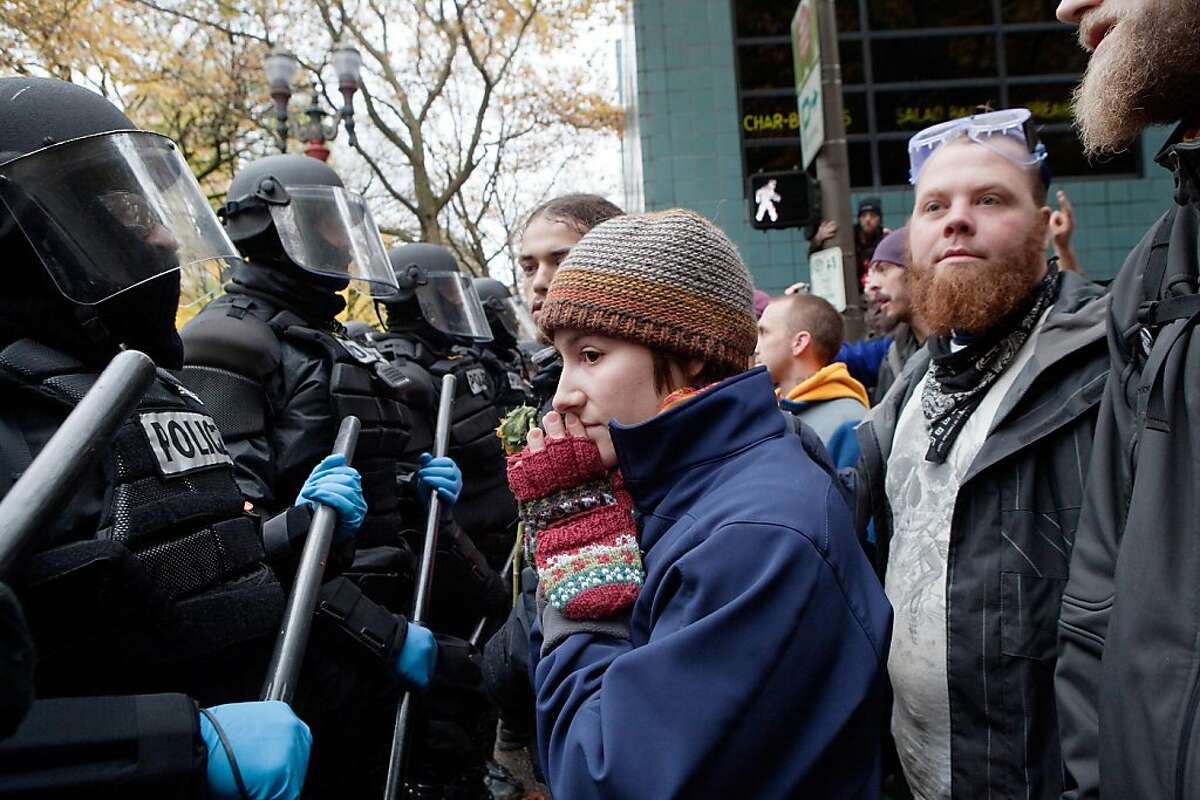 PORTLAND - NOVEMBER 13: A protester pleads with police during a demonstration near the Occupy Portland encampment November 13, 2011 in Portland, Oregon. Portland police have reclaimed the two parks in which occupiers have been camping after a night of brinksmanship with protesting crowds of several thousands. (Photo by Natalie Behring/Getty Images)