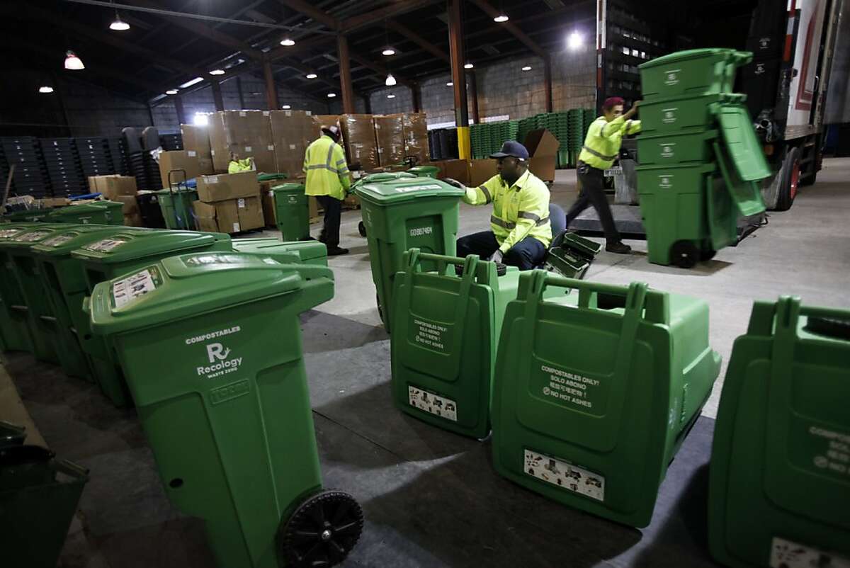 Marcus Tiger, center, Alfredo Guzman, right, and Maurice Lige, left, assemble compost bins and get them ready for delivery at the transfer station in San Francisco, Calif., Monday, November 21, 2011. Recology is about to hit one million tons of compost since they began in 1996. Ran on: 11-22-2011 Recology workers Maurice Lige (left), Marcus Tiger and Alfredo Guzman assemble compost bins for delivery at the transfer station in S.F. The firm expects to hit the 1-million-ton mark with collections today.