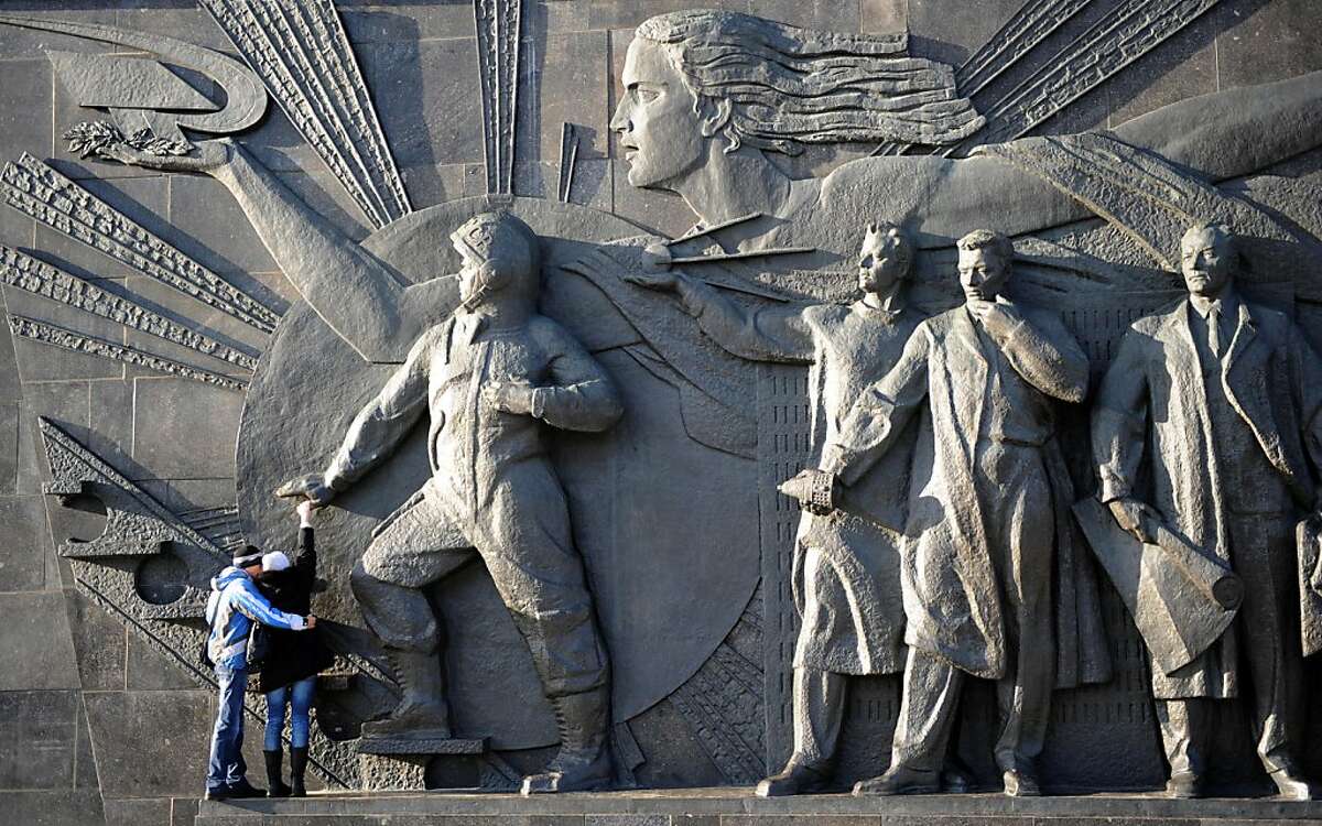 People look at "To Conquerors of Space" bas-relief on a wall of the Cosmonautics Memorial Museum in Moscow, on November 20, 2011. The museum in charts the history of the Russian space race. AFP PHOTO / KIRILL KUDRYAVTSEV (Photo credit should read KIRILL KUDRYAVTSEV/AFP/Getty Images)