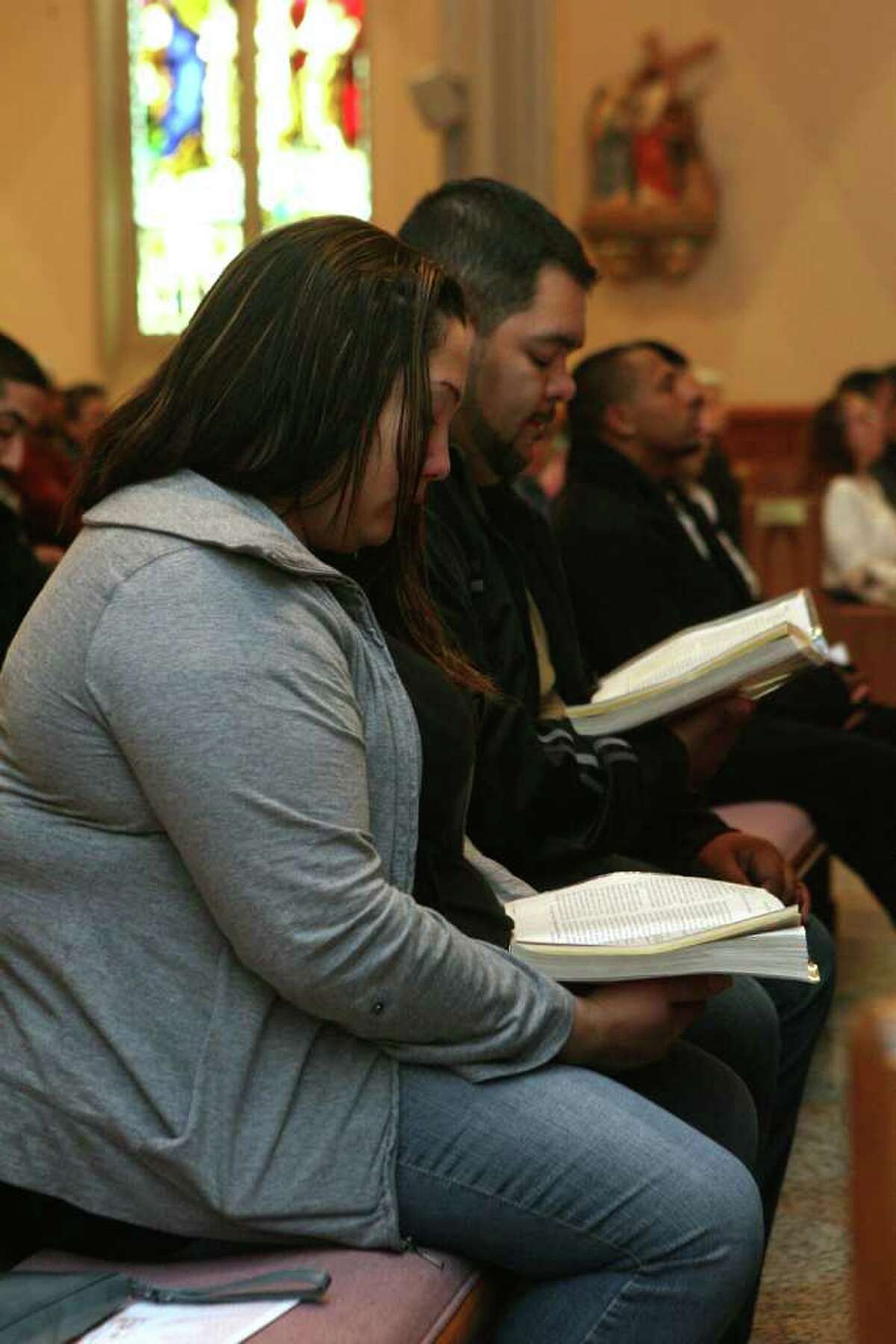 Nicole and Miguel Arbelo, of Bridgeport, attend mass at St. Augustine's Cathedral on Sunday, November 20, 2011. The changes in the Mass liturgy will begin next Sunday.