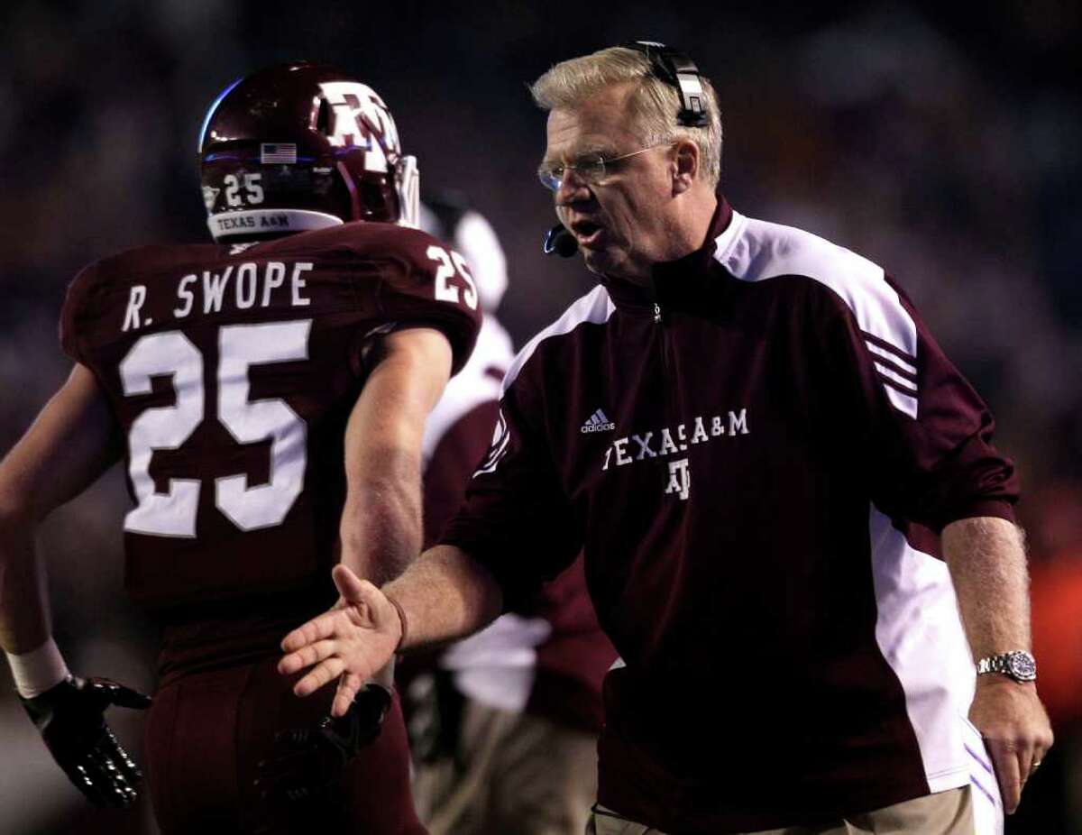 Texas A&M head coach Mike Sherman greets his players after the Aggies scored against Texas during the first quarter of an NCAA college football game at Kyle Field Thursday, Nov. 24, 2011, in College Station.