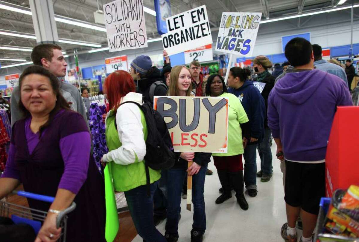 Protesters march through Walmart in Renton during an Occupy Seattle protest at the retailer on Black Friday.