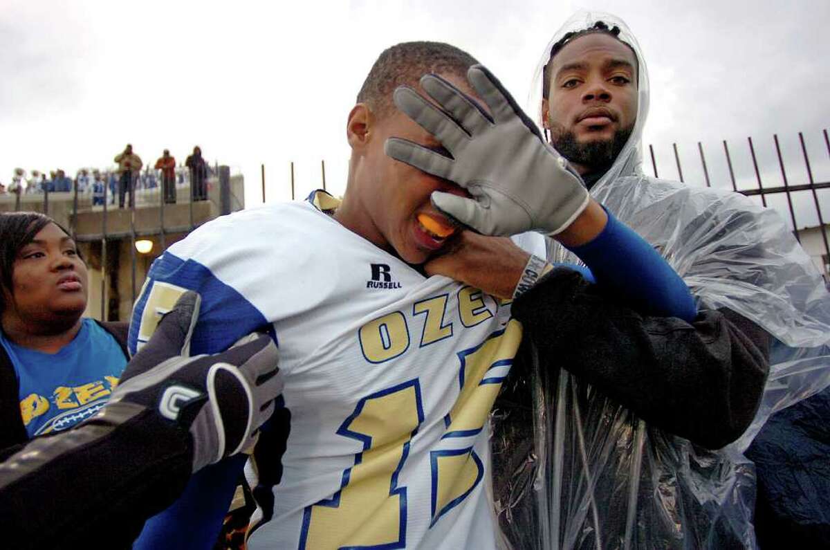 An Ozen player runs pepper spray from his face after a large brawl between the Panthers and La Marque players at Stallworth Stadium on Saturday. Security officials used pepper spray to break up the melee which followed a smaller scuffle occurring in the fourth quarter. Photo taken Saturday, November 26, 2011 Guiseppe Barranco/The Enterprise