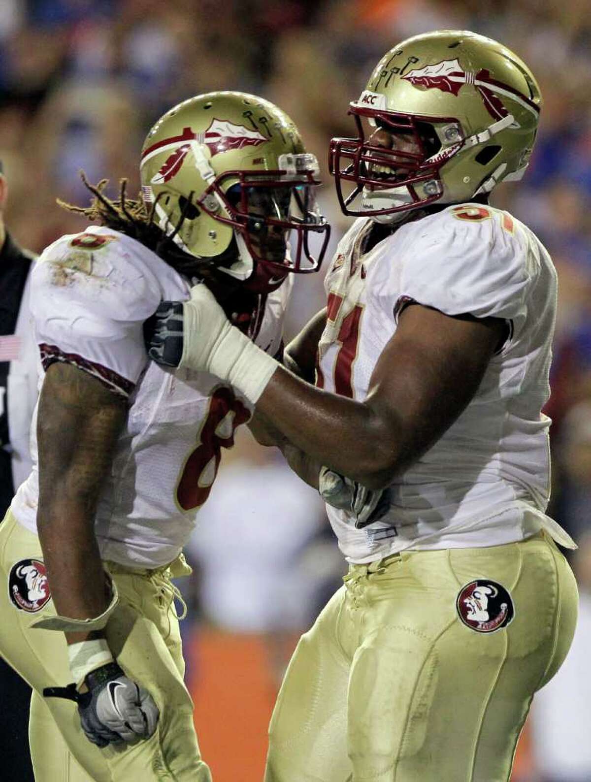 Florida State running back Devonta Freeman (left) is congratulated offensive linesman Bobby Hart after his 1-yard touchdown run.