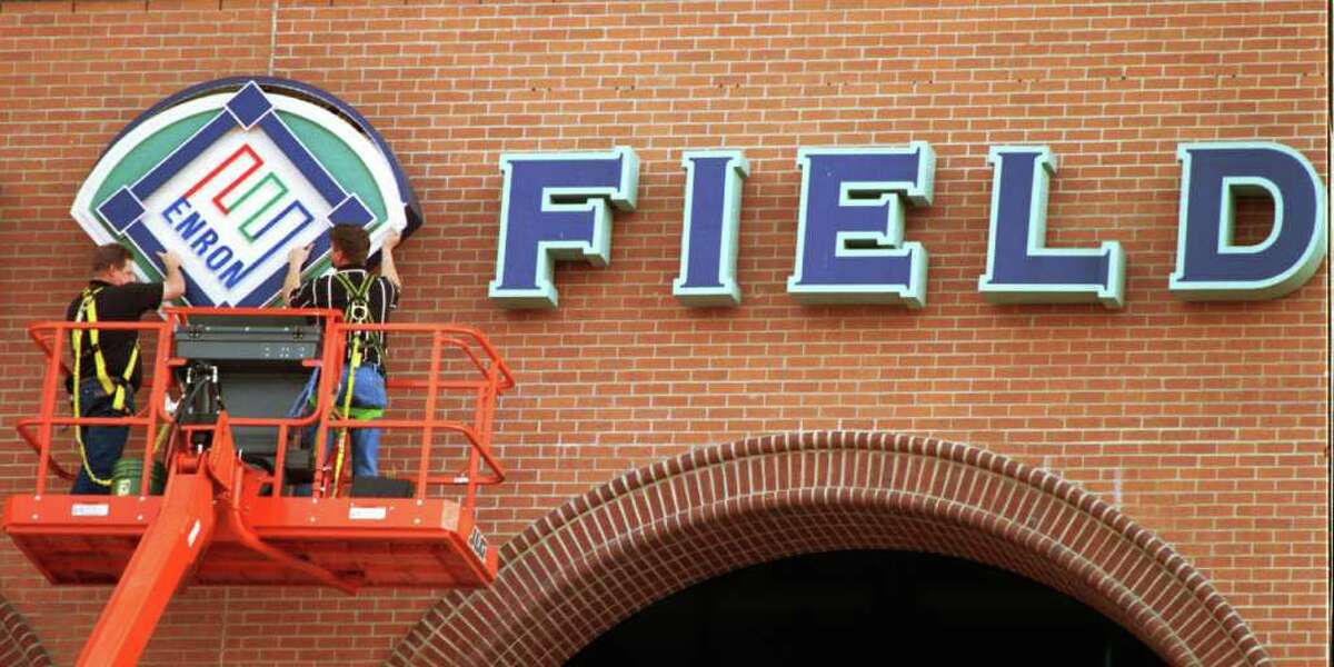Lowell Matheny, left, and David Mckenzie remove the Enron logo from the Houston Astros ballpark in March 2002. The club, then owned by Drayton McLane, bought back the naming rights after the energy company went bankrupt.