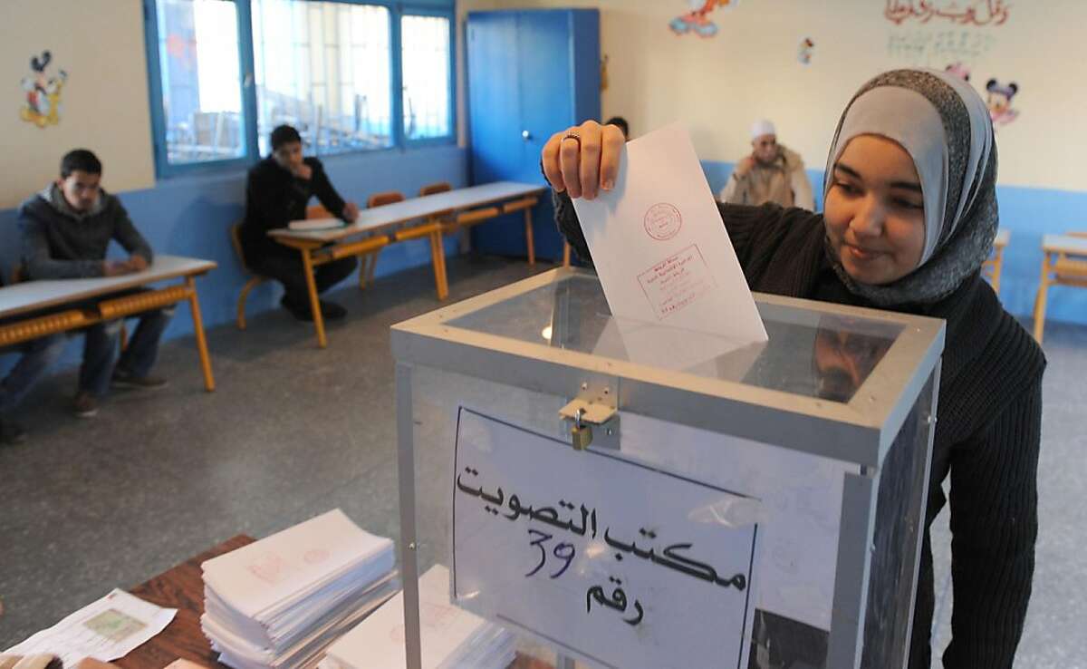 A Moroccan voter casts her ballot in the legislative election at a polling station in Rabat on November 25, 2011. Moroccans voted in the country's first legislative election since the constitution was reformed to give parliament more power, with an Islamist party expected to post strong gains. The election, the second in north Africa since the Arab Spring uprisings began, pits the moderately Islamist Justice and Development party against a coalition loyal to King Mohammed VI. AFP PHOTO / ABDELHAK SENNA (Photo credit should read ABDELHAK SENNA/AFP/Getty Images)