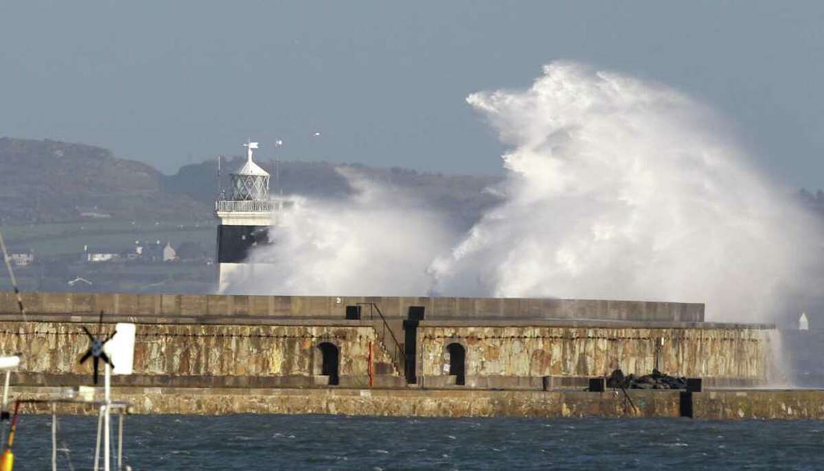 Holyhead breakwater is seen during high seas, Sunday Nov. 27, 2011. Six people are missing and two have been rescued after a cargo ship sank in the Irish Sea early on Sunday in gale force winds off the coast of north Wales, British authorities said. Holyhead Coastguard said the Swanland cargo ship, with eight people on board and carrying thousands of tons of limestone, sent a mayday call reporting that the vessel's hull had cracked in poor weather conditions. (AP Photo/Peter Byrne, PA) UNITED KINGDOM OUT NO SALES NO ARCHIVE